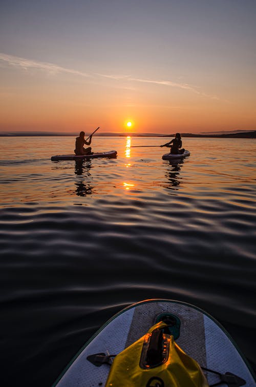 Free People on Kayak During Sunset Stock Photo